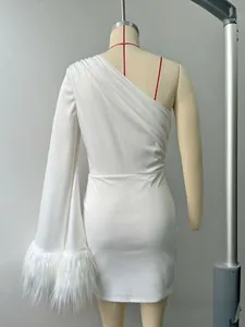 Detail of white one-shoulder dress with faux fur trim on sleeve and ruched fabric texture
