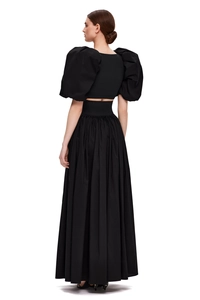 Detail of black puff sleeve crop top and high waist pleated maxi skirt set