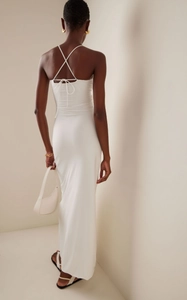 Detail of white bodycon halter maxi dress featuring a backless design and tie strap closure