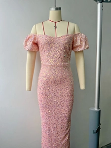 Close-up of sparkling pink sequins and puff sleeves on this stunning evening dress