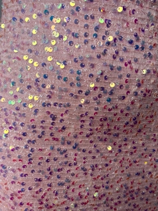 Close-up of pink mesh fabric with iridescent sequins for sequin evening dress detail