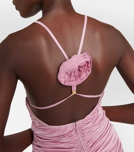 Detail of pink backless dress showing 3D fabric rose and ruching texture on straps