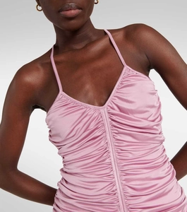 Detail of pink ruched satin dress featuring vertical seam and 3D floral textures