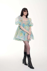 Detail of floral puff sleeve tiered dress featuring vintage print and layered tulle texture