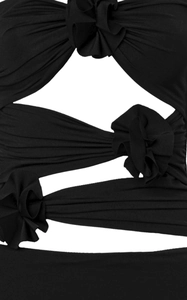 Detail of 3D fabric flowers and geometric cut-out design on a slim black summer dress
