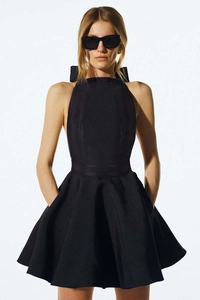 Detail of the elegant back bow-tie design on this black backless A-line evening dress