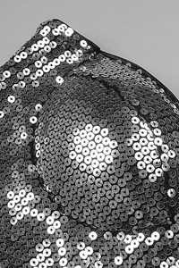 Detail of silver sequins on strapless party top showing intricate sewing craftsmanship