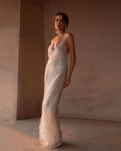 Detail of elegant white fringe dress showing intricate texture and high side slit