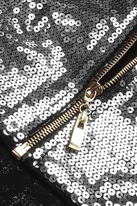 Detailed macro shot of shimmering black and white sequins with a premium metal zipper
