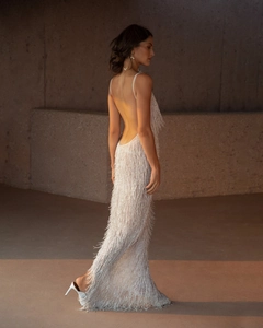 Detail of the open-back design on this white fringed evening dress with slim straps