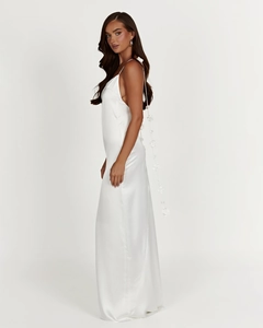 Detail view of the back of white satin maxi dress featuring 3D floral accent and tie-back