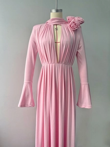 Detail of pink halter dress with large 3D floral accents and elegant cut-out neckline