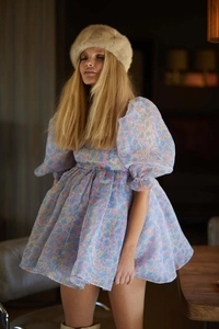 Close-up of floral puff sleeve organza mini dress with vibrant vintage court patterns