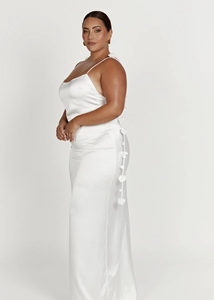 Close-up of white satin slip maxi dress with 3D floral details and slender straps