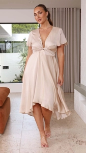 Detail of champagne satin dress showing deep V-neck and twist knot waist design