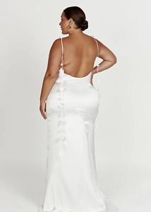 Detail of backless white satin maxi dress with floral straps and elegant silk texture