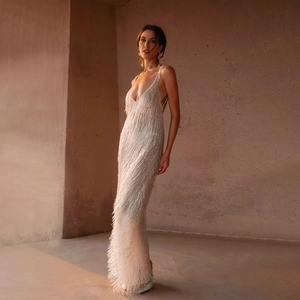 Elegant white backless fringe maxi dress with deep V-neck and delicate straps