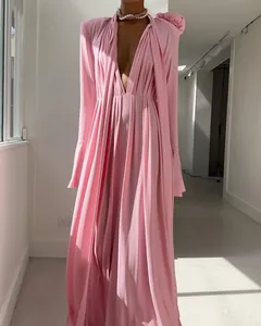 Close-up of pink deep V-neck dress featuring elegant draped pleats and silky fabric texture