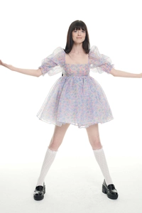Detail of floral organza dress with puff sleeves and square neckline in macro view