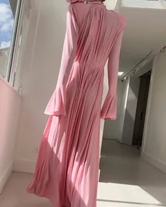 Detail of elegant pink maxi dress showing back view and sophisticated pleating texture