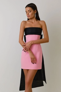 Detail of evening dress with pink body, oversized black bow and semi-sheer tulle train