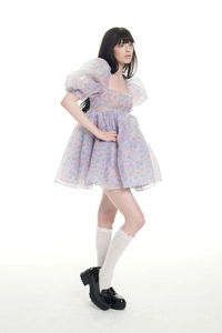 Close-up of floral organza puff sleeve dress with colorful patterns and waist detail