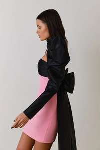 Detail of oversized bow and puff sleeves on black and pink dress set