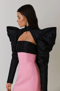 Detail view of the textured black puff sleeves and pink strapless dress ensemble