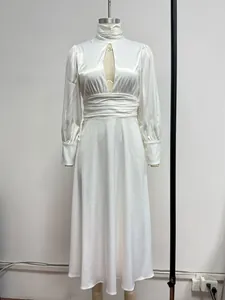 Detail of white satin evening dress featuring high neck, deep V cutout and puffy sleeves