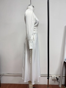 Detailed side view of white satin evening dress with high neck and puffed sleeves
