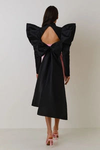 Close-up of diamond back cutout with oversized bow and structured puff sleeves