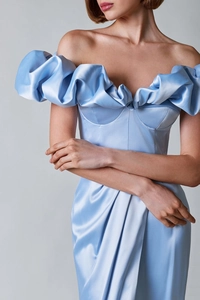 Detailed view of light blue satin dress featuring elegant ruffles and off-shoulder neckline