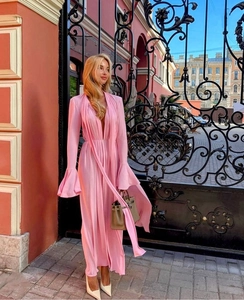 Detail of pink deep V-neck maxi dress with wide bell sleeves and flowing chiffon fabric