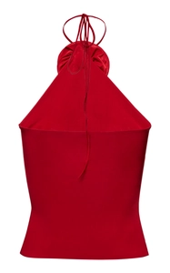 Detail of red halter neck top featuring glossy satin fabric and elegant tie neck design