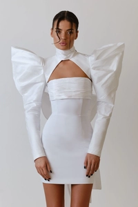 Detail of white evening dress with oversized puff sleeves and hollowed chest cutouts