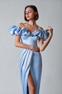 Close-up of elegant ruffled off-shoulder neckline on a light blue satin evening dress