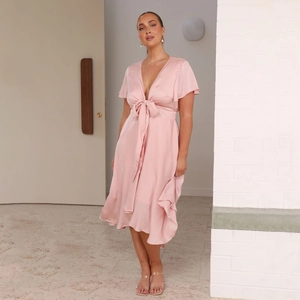 Elegant light pink V-neck dress with irregular high-low hem and waist bow tie ribbon