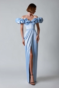 Detail of light blue off-shoulder evening gown with ruffled sleeves and high side slit