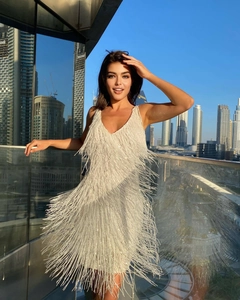 Détails de franges blanches superposées et paillettes scintillantes sur la robe