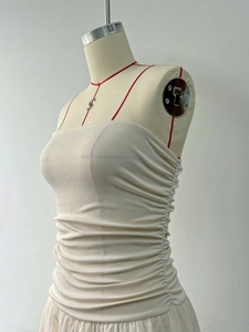 Detail of off-white tube top dress with ribbed cotton texture and ruched side detail