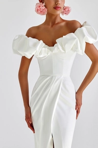 Close-up of elegant off-shoulder white satin dress featuring ruffled puff sleeves and a side slit