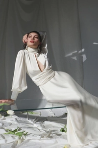 Macro detail of elegant white satin dress with high neck and front cutout design