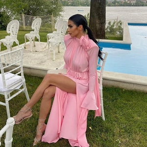 Pink halter long dress with 3D floral accent, flared sleeves, and side high slit