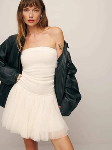 Detail of white pleated tulle skirt paired with a black leather jacket for women