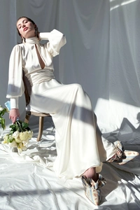 Detail of the elegant cream satin evening dress with high neck and front cutout design