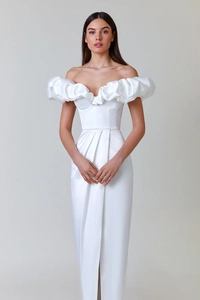 Detail of elegant off-shoulder white evening gown featuring ruffled layers and side slit