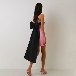 Elegant pink tube dress with large black back bow and long train for formal occasions