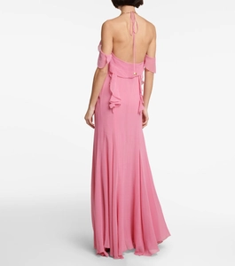 Detail of the elegant open back and layered ruffles on this pink chiffon evening dress