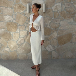 Chic white two-piece crochet set with V-neck tie-front top and slim-fit knit maxi skirt