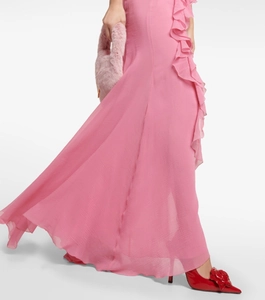 Detail of pink ruffled evening dress with side slit and flowing chiffon fabric